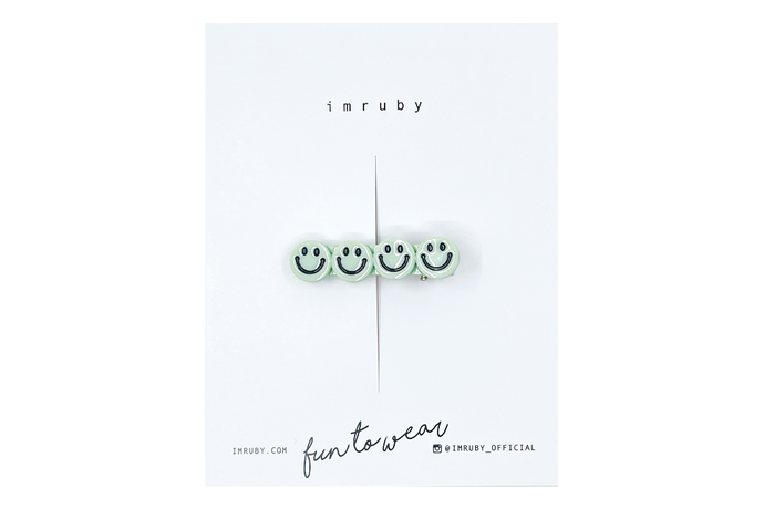 Hi! I'm BREGJE, a soft mint smiley clip.

Hold back bangs, clip back hair, or simply use for stylistic purposes by adding some flair to your hair. Mix-and-match, and layer these hair clips or wear on their own for a soft, seasonal look.