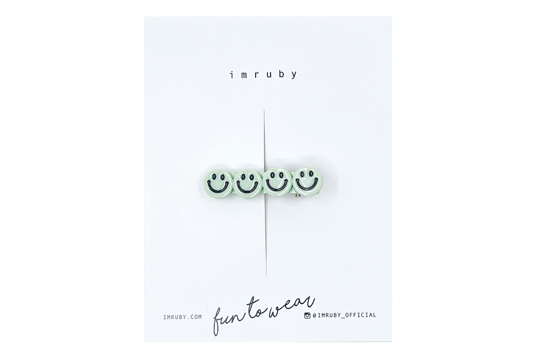 Hi! I'm BREGJE, a soft mint smiley clip.

Hold back bangs, clip back hair, or simply use for stylistic purposes by adding some flair to your hair. Mix-and-match, and layer these hair clips or wear on their own for a soft, seasonal look.